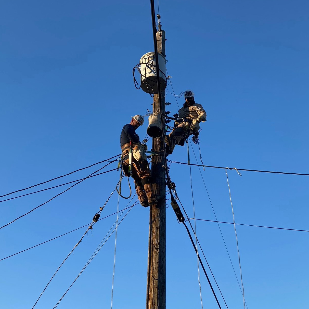 OPPD employees repairing lines on pole